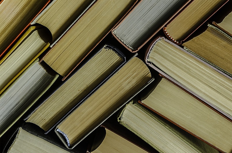 a stack of colorful books in a library or a room