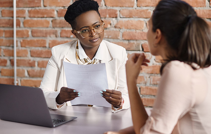 A coach or trainer talking with a client.