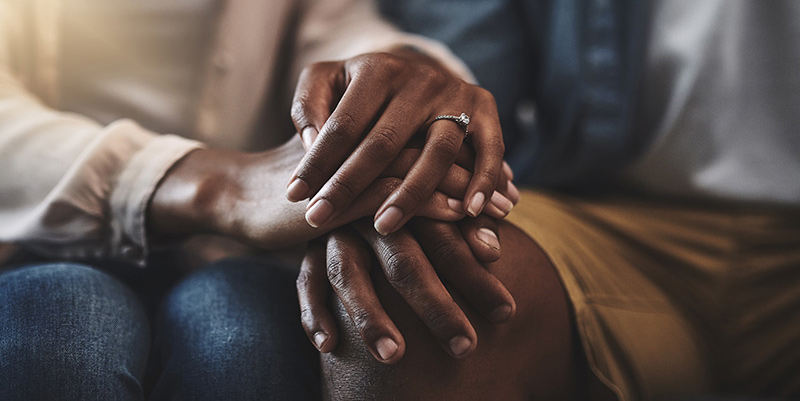 Closeup of married couple holding hands