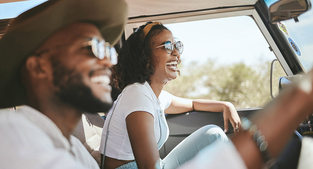 Couple smiling riding in a car.