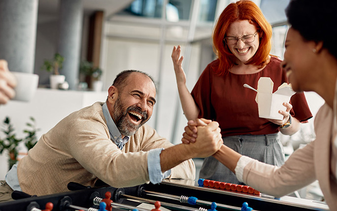 Coworkers playing games together and celebrating