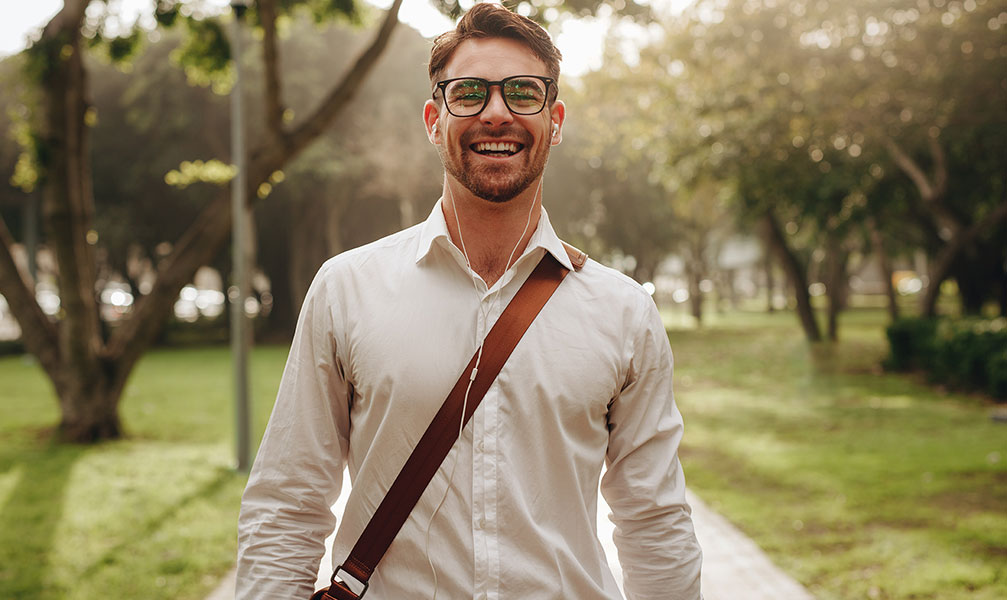 Happy man walking down sidewalk